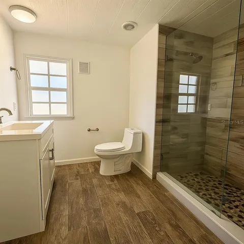 a bathroom with a sink toilet and shower