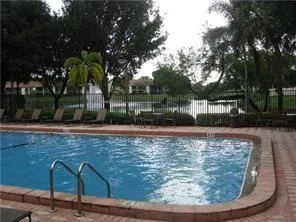 a view of a swimming pool with a patio