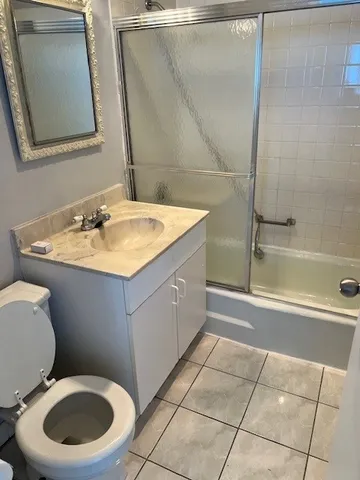 a bathroom with a sink toilet and mirror