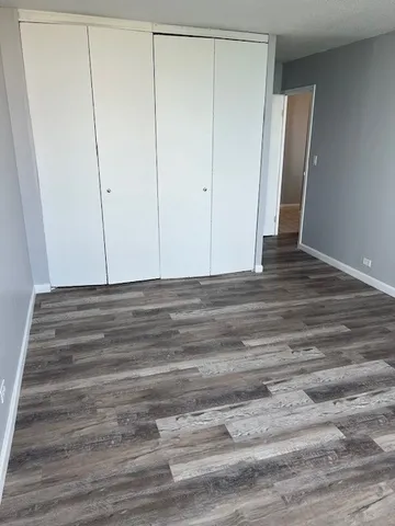 a view of room with wooden floor