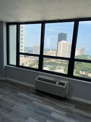 a view of a floor to ceiling window and wooden floor