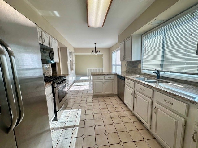 2301 Modaff Road Naperville, IL 60565 - Photo 6 of 24 a large kitchen with a stove a sink dishwasher a refrigerator and cabinets