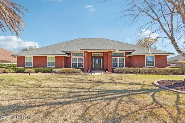 a front view of a house with a yard and seating space