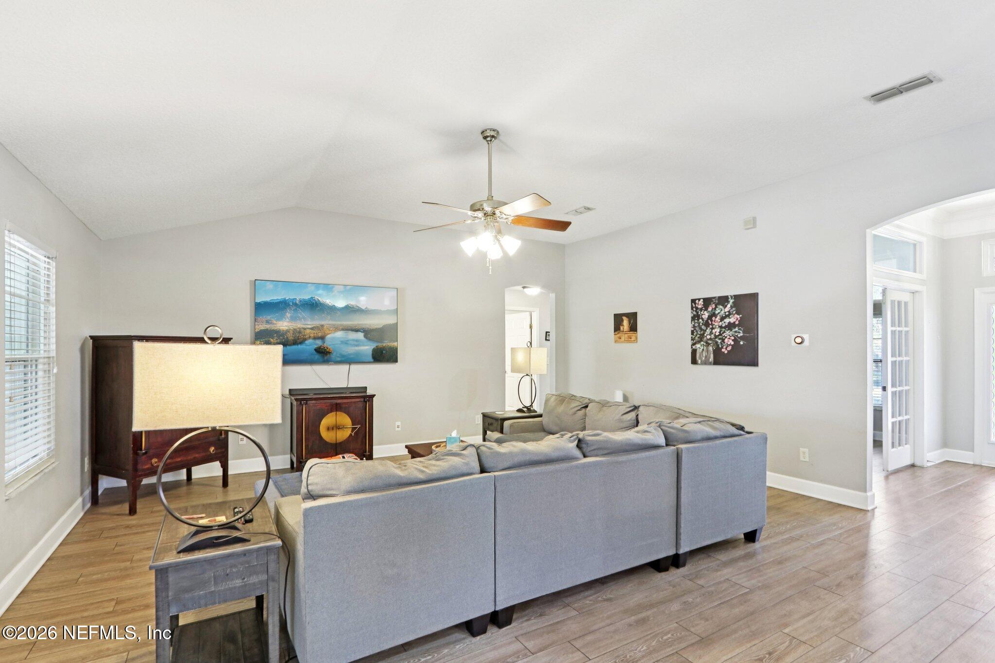 1405 Sinclair Lane Jacksonville, FL 32221 - Photo 12 of 37 a living room with furniture a fireplace and a flat screen tv