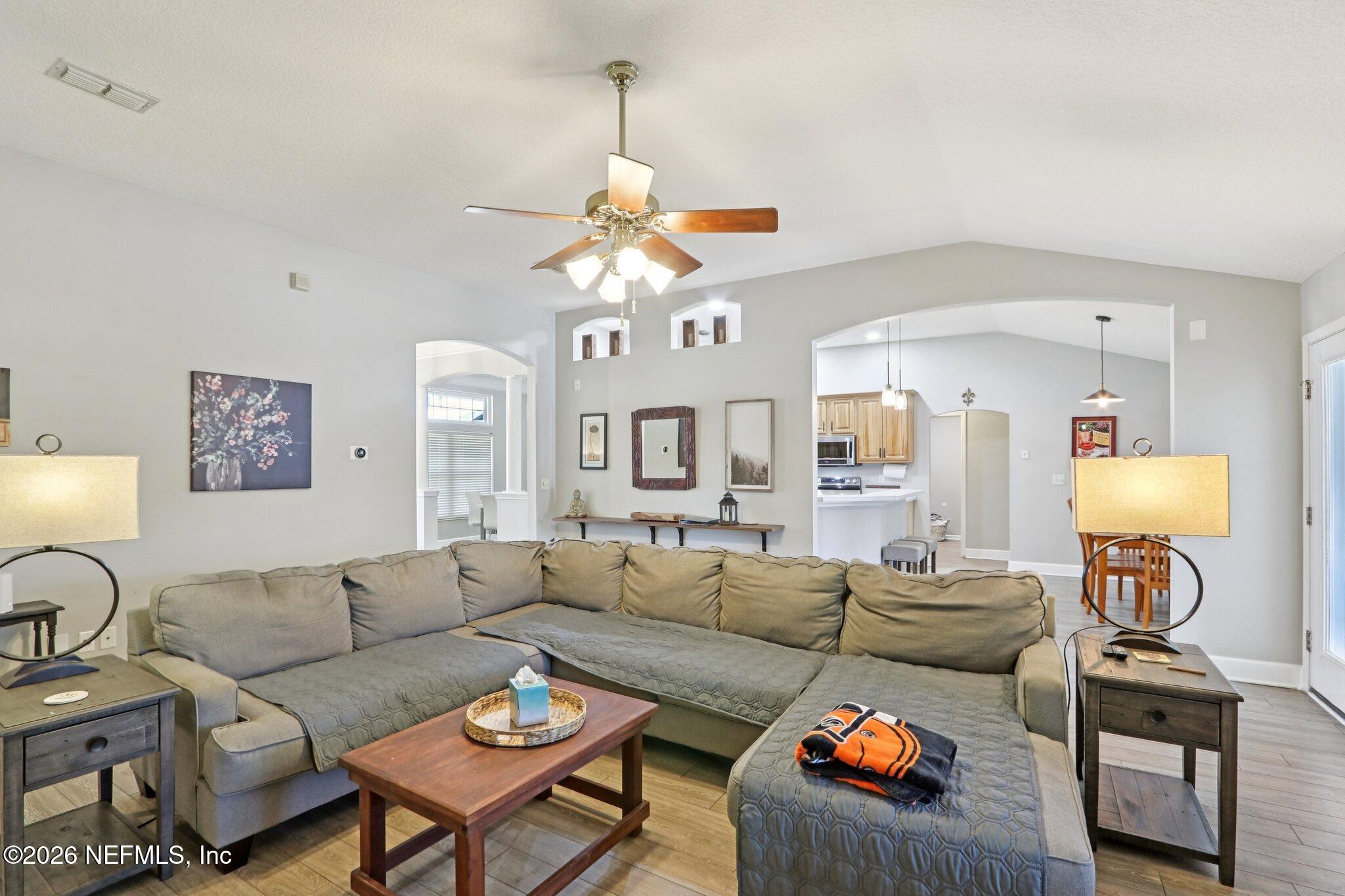 1405 Sinclair Lane Jacksonville, FL 32221 - Photo 14 of 37 a living room with furniture a rug and a chandelier