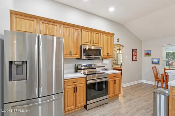 a kitchen with stainless steel appliances a refrigerator stove and microwave