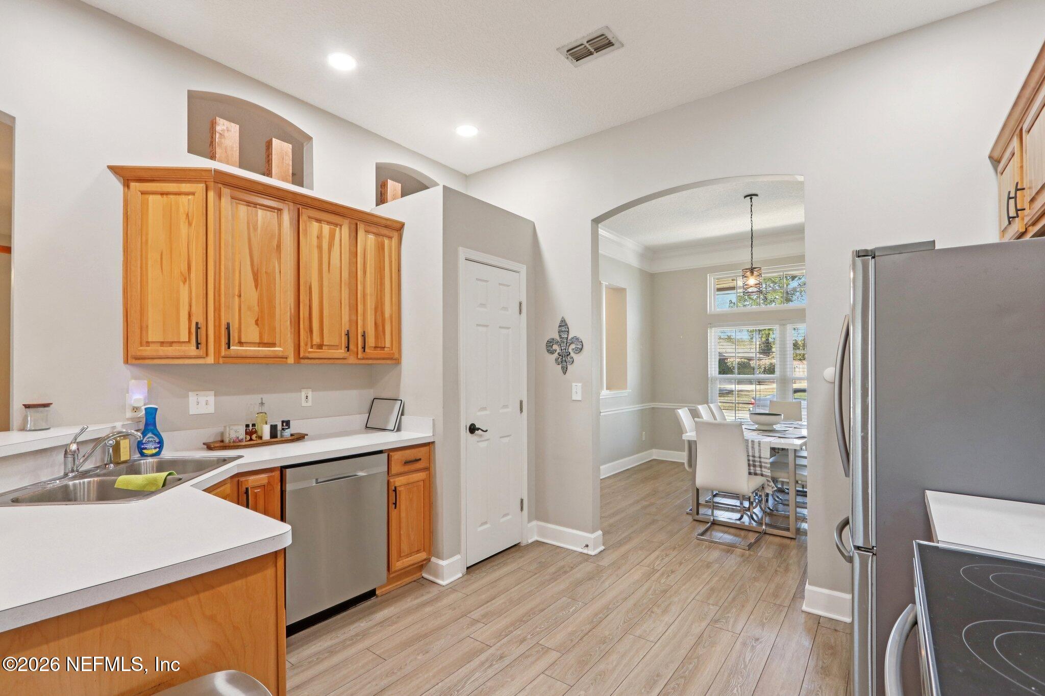 1405 Sinclair Lane Jacksonville, FL 32221 - Photo 19 of 37 a kitchen that has a sink in it and wooden floors