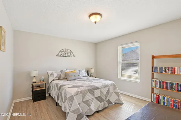 a bedroom with a bed and a book shelf