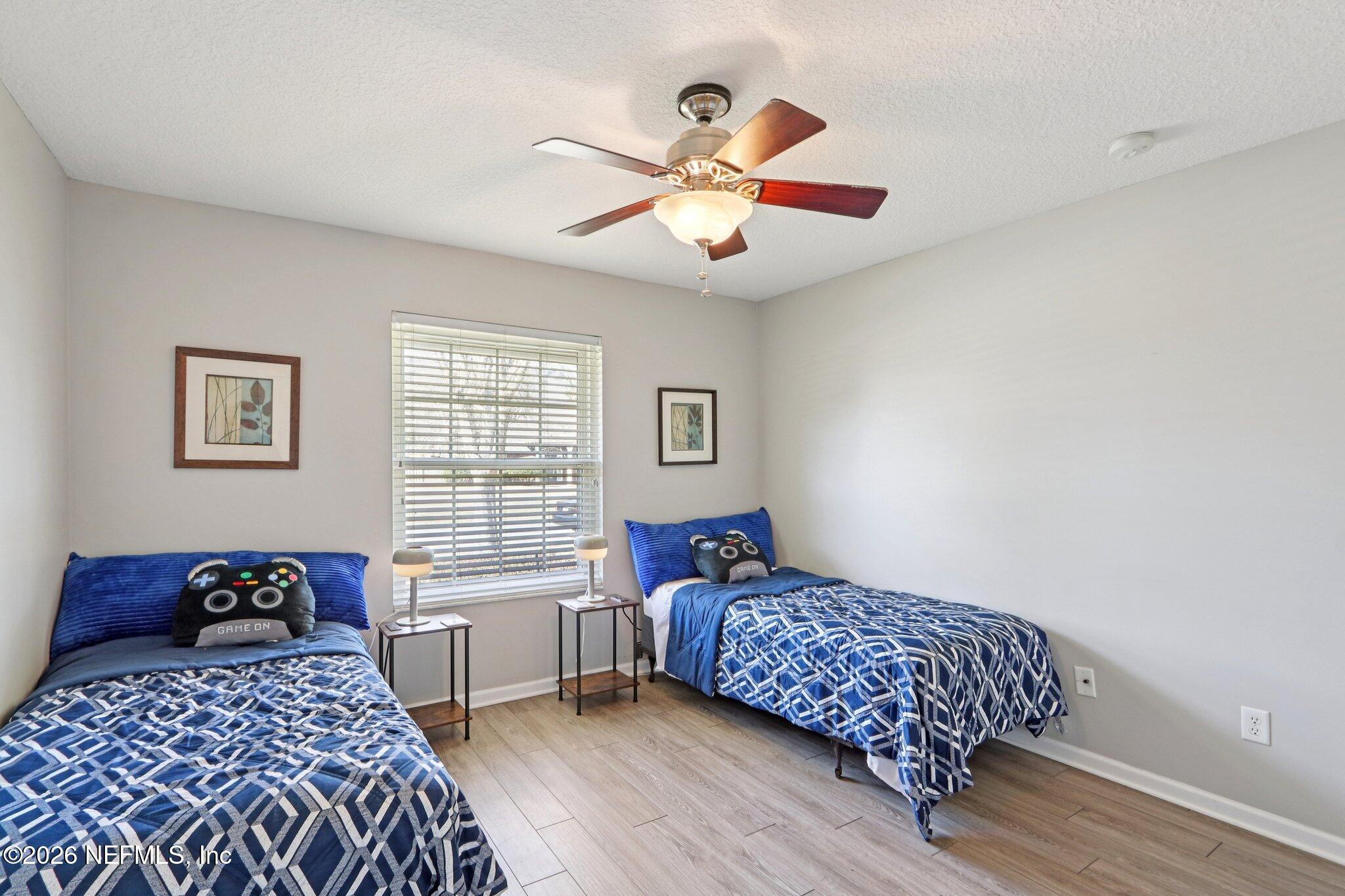 1405 Sinclair Lane Jacksonville, FL 32221 - Photo 24 of 37 a bedroom with a bed and a chandelier