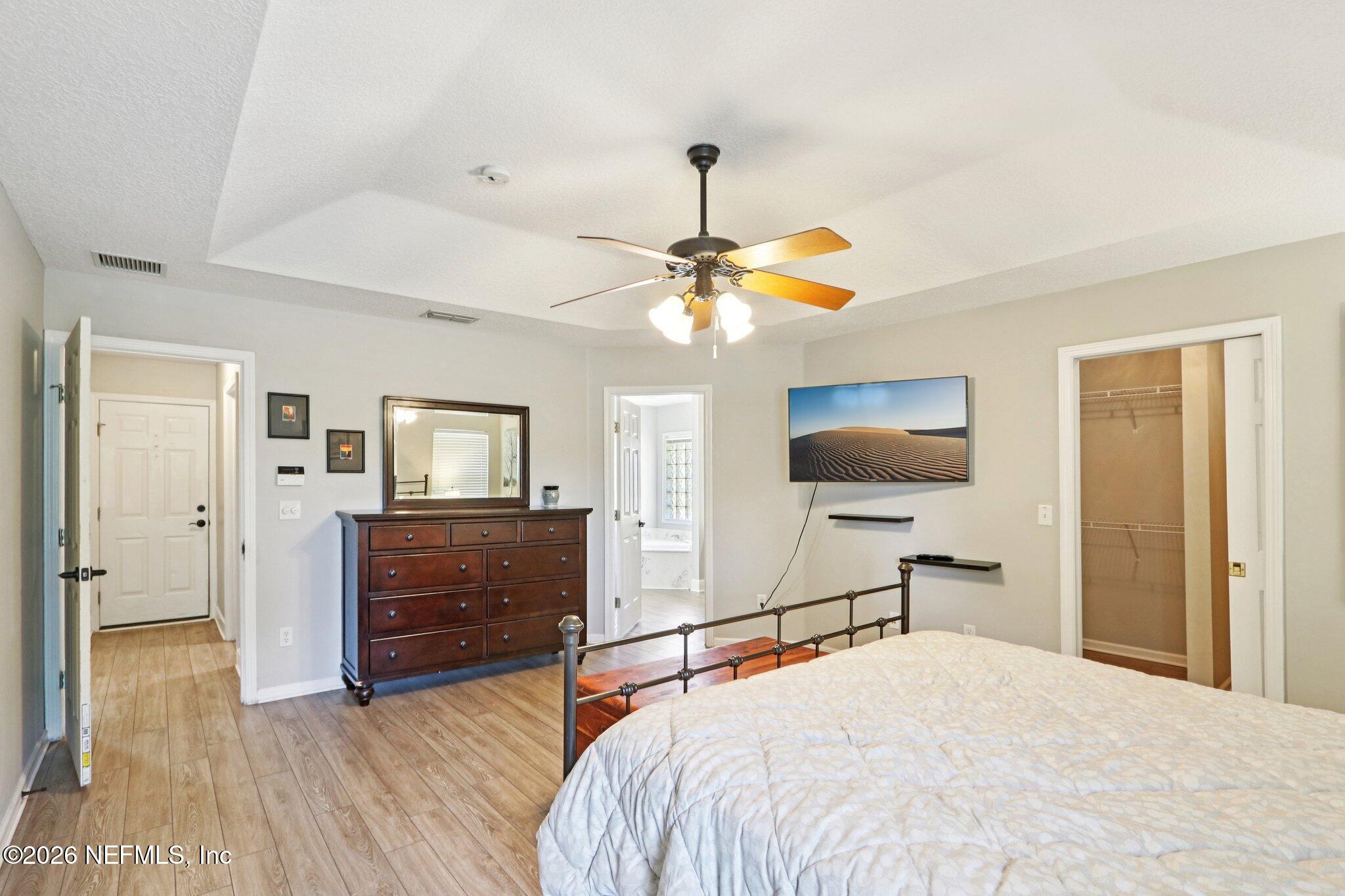 1405 Sinclair Lane Jacksonville, FL 32221 - Photo 26 of 37 a bedroom with a bed and a chandelier