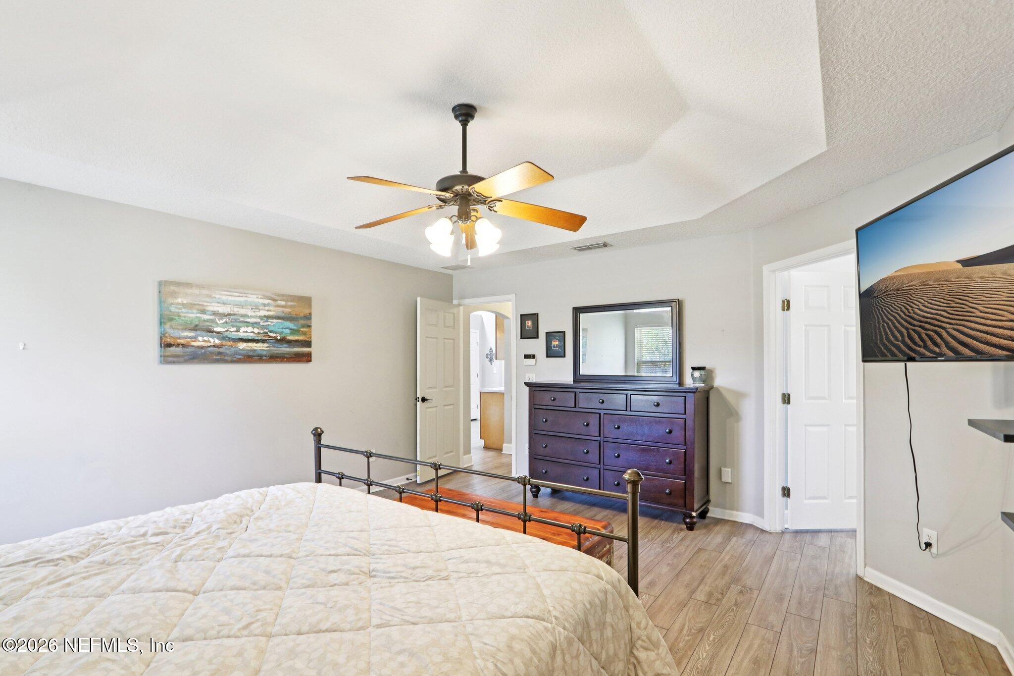 1405 Sinclair Lane Jacksonville, FL 32221 - Photo 27 of 37 a bedroom with a bed and a chandelier