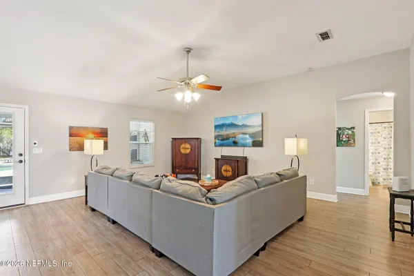 a living room with furniture and a chandelier