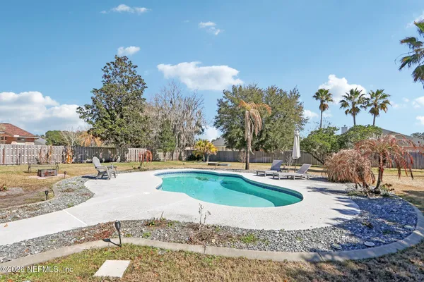 a view of a house with swimming pool and sitting area