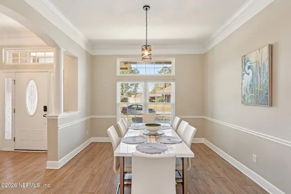 a view of a dining room with furniture window and wooden floor