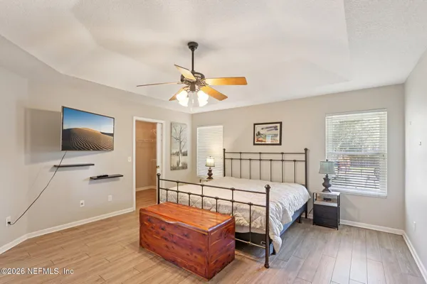 a bedroom with a bed couch and a window