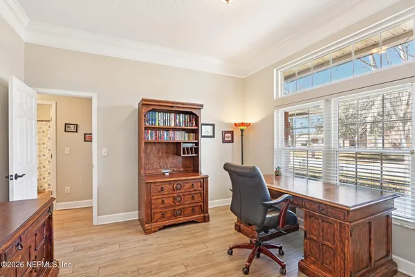 a view of a workspace with furniture and a window