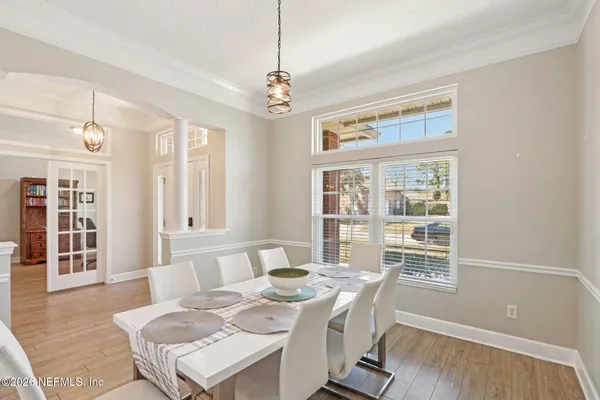 a view of a dining room with furniture window and wooden floor