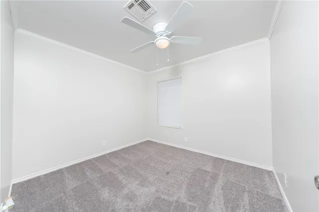 an empty room with a window and a ceiling fan