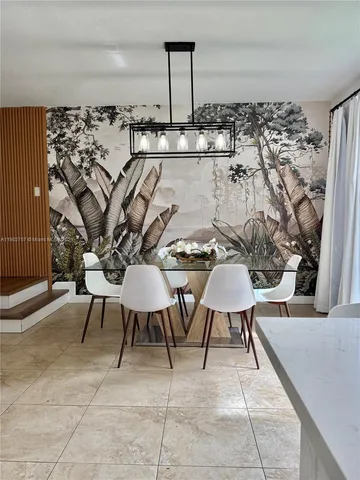 a balcony with chairs and white appliances