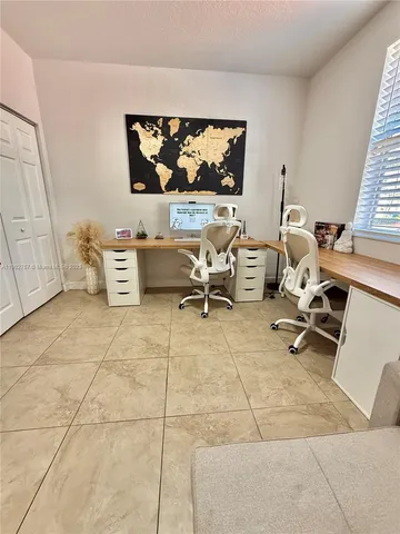 a living room with furniture a rug and white walls
