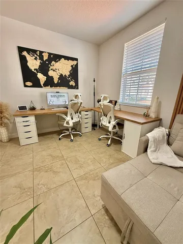 a living room with furniture and painting on the wall