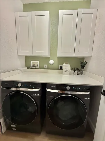 a utility room with sink dryer and washer