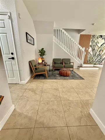 a living room with furniture and a rug