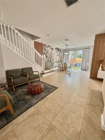 a bedroom with furniture and a rug