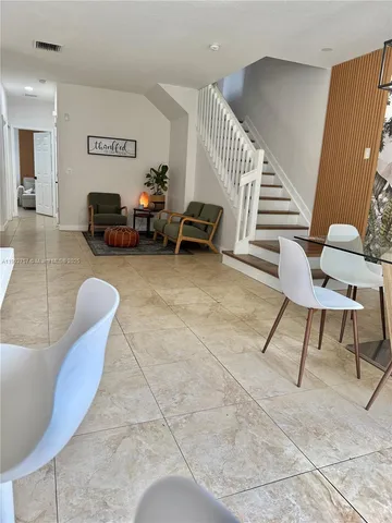 a living room with furniture and a chair