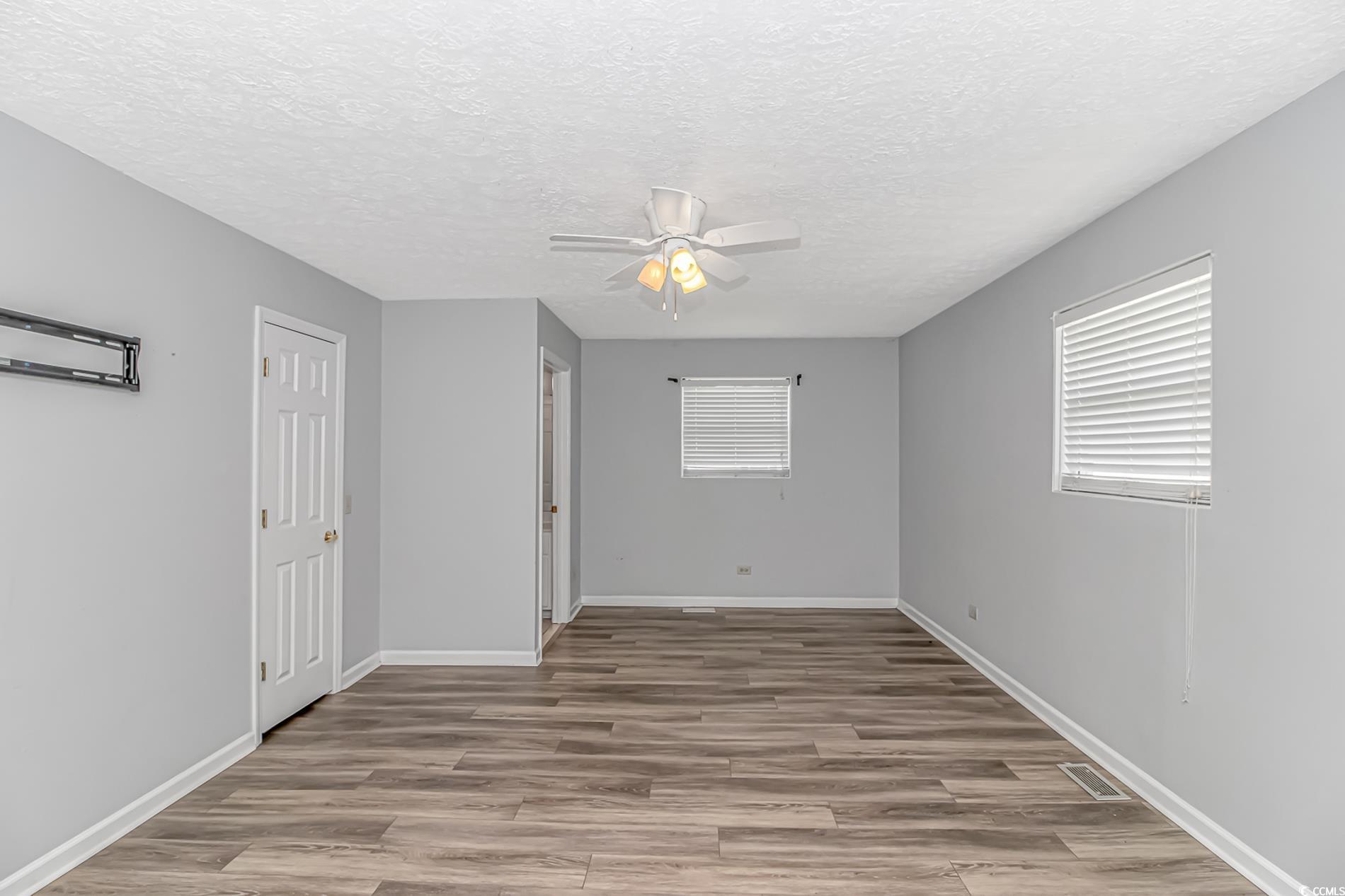 2829 Highway 129 Galivants Ferry, SC 29544 - Photo 17 of 40 Empty room with a ceiling fan, wood finished floors, and a textured ceiling