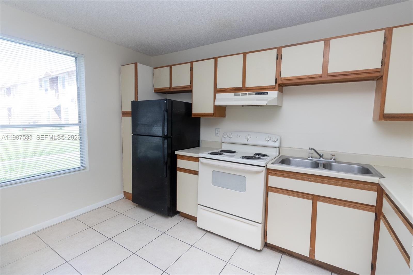 2157 Southwest 80th Terrace, Unit 2157 Miramar, FL 33025 - Photo 2 of 29 a kitchen with a stove a refrigerator and a sink