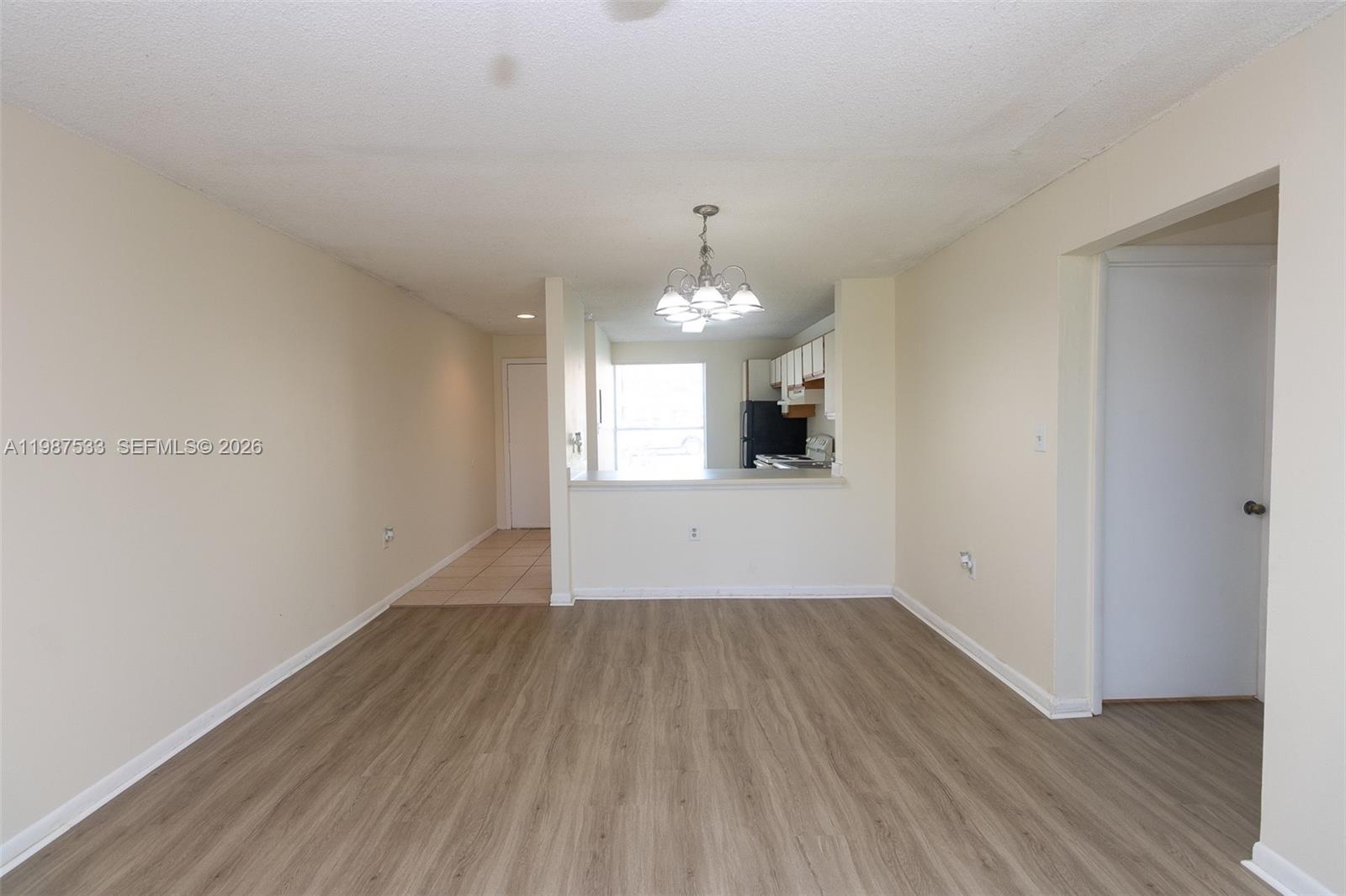 2157 Southwest 80th Terrace, Unit 2157 Miramar, FL 33025 - Photo 7 of 29 wooden floor in an empty room with a window