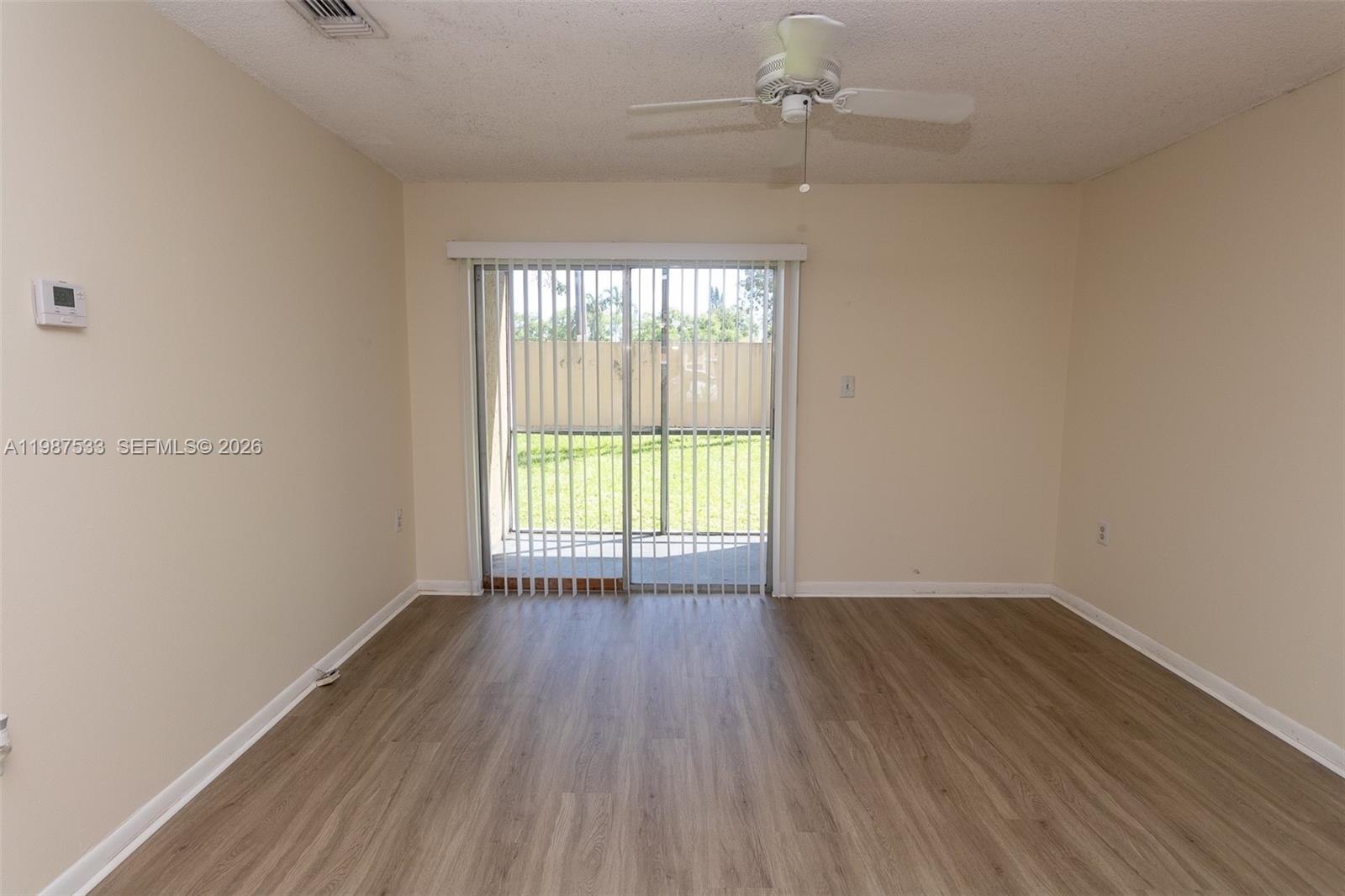 2157 Southwest 80th Terrace, Unit 2157 Miramar, FL 33025 - Photo 9 of 29 wooden floor in an empty room with a window