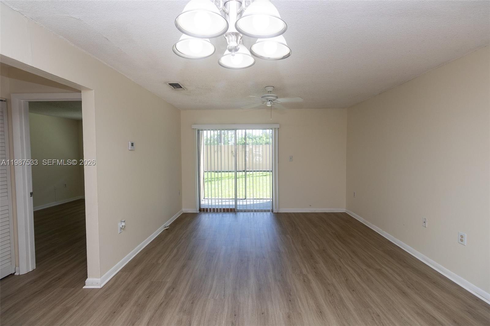 2157 Southwest 80th Terrace, Unit 2157 Miramar, FL 33025 - Photo 10 of 29 an empty room with wooden floor and windows