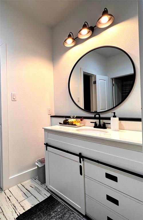 403 North Nash Street Kaufman, TX 75142 - Photo 15 of 18 a bathroom with a sink and mirror