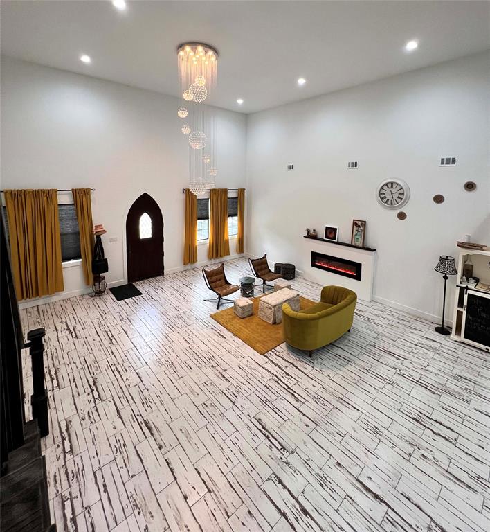 403 North Nash Street Kaufman, TX 75142 - Photo 2 of 18 a bed room with furniture and a chandelier