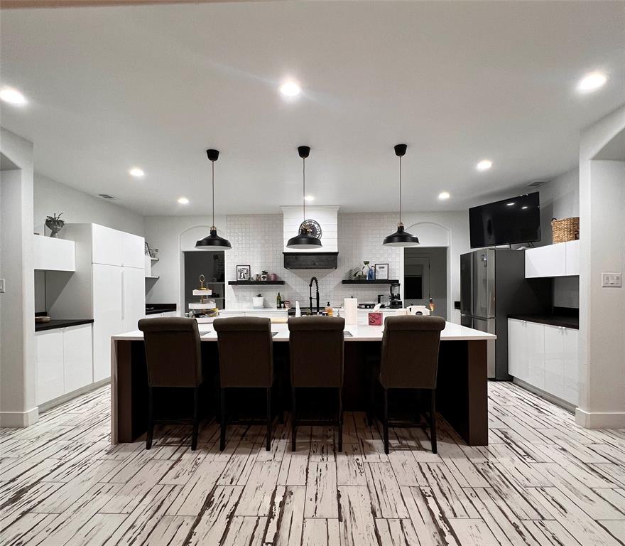 403 North Nash Street Kaufman, TX 75142 - Photo 9 of 18 a living room with stainless steel appliances kitchen island granite countertop furniture a wooden floor and a chandelier