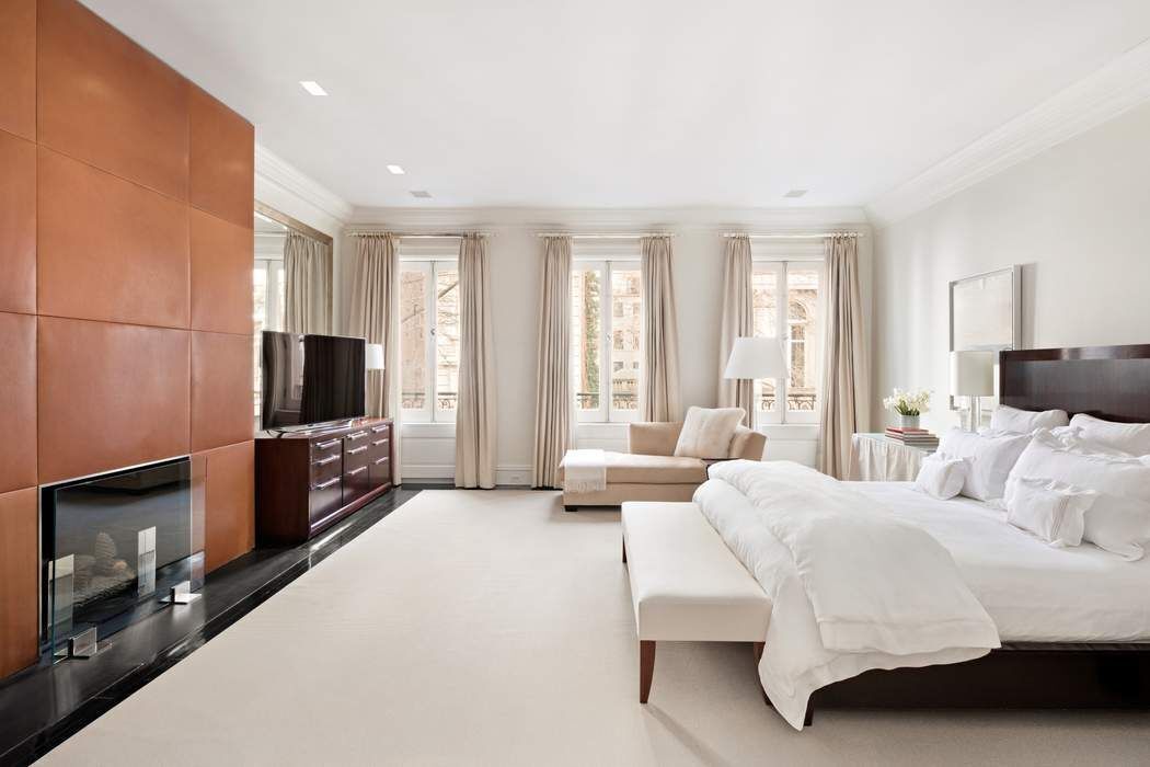 10 East 73rd Street Manhattan, NY 10021 - Photo 10 of 16 a bedroom with furniture and a flat screen tv