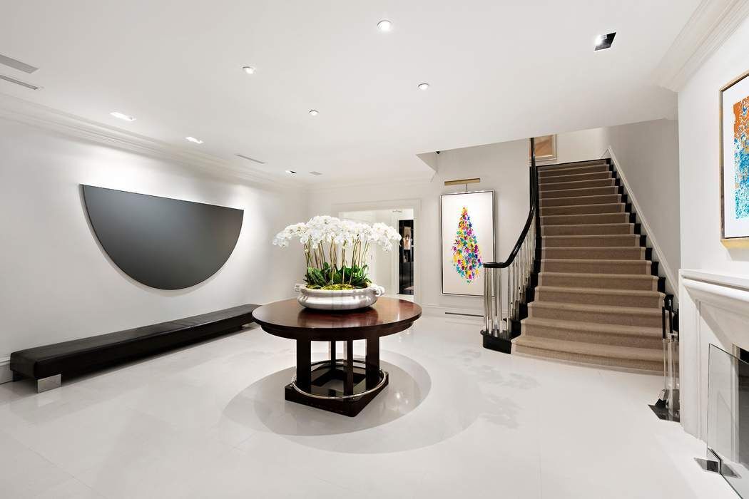 10 East 73rd Street Manhattan, NY 10021 - Photo 2 of 16 a living room with furniture and a wooden floor