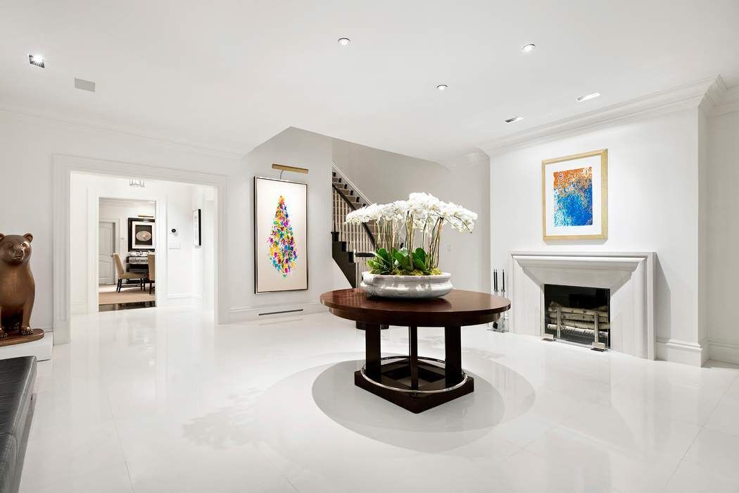 10 East 73rd Street Manhattan, NY 10021 - Photo 3 of 16 a living room with furniture and a fireplace