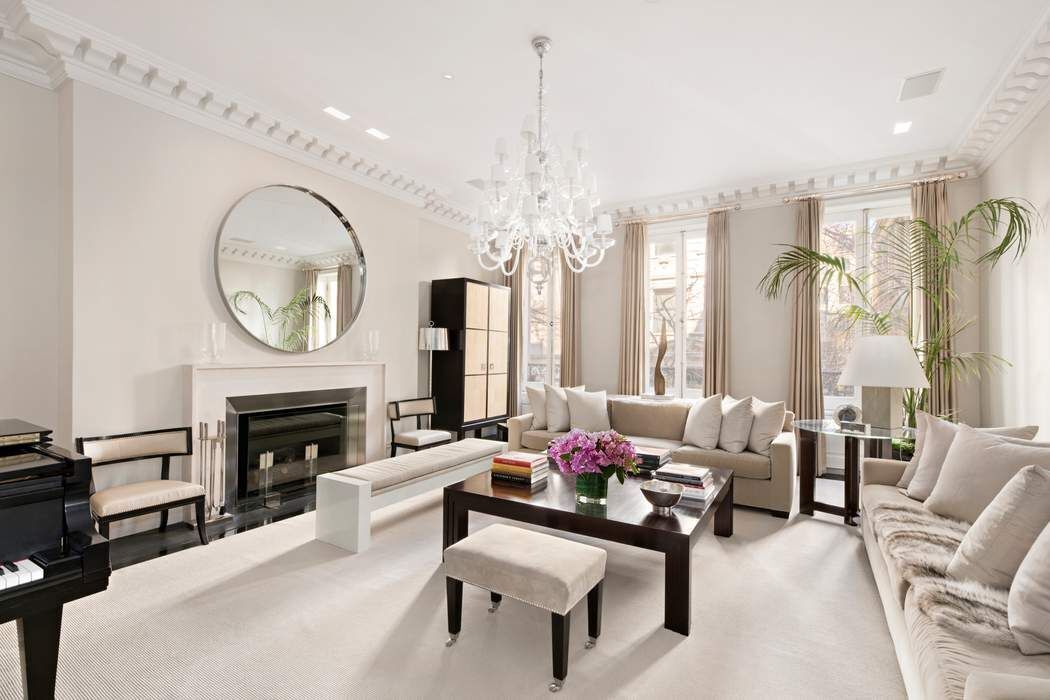 10 East 73rd Street Manhattan, NY 10021 - Photo 7 of 16 a living room with furniture a fireplace and a chandelier