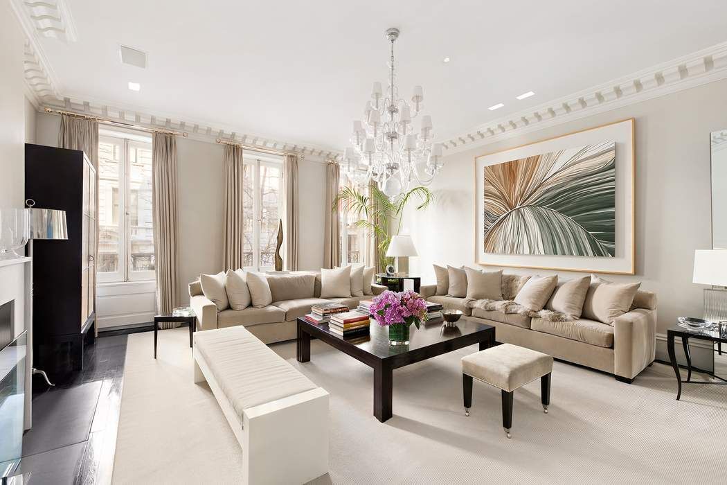 10 East 73rd Street Manhattan, NY 10021 - Photo 8 of 16 a living room with furniture and a chandelier