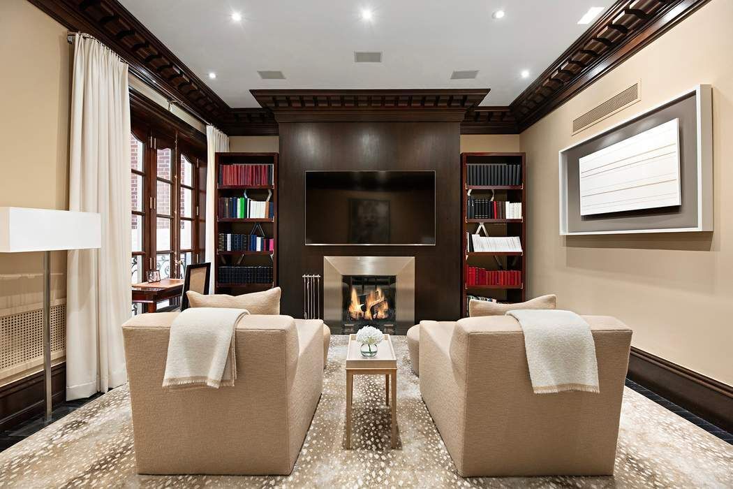 10 East 73rd Street Manhattan, NY 10021 - Photo 9 of 16 a living room with fireplace furniture and a flat screen tv