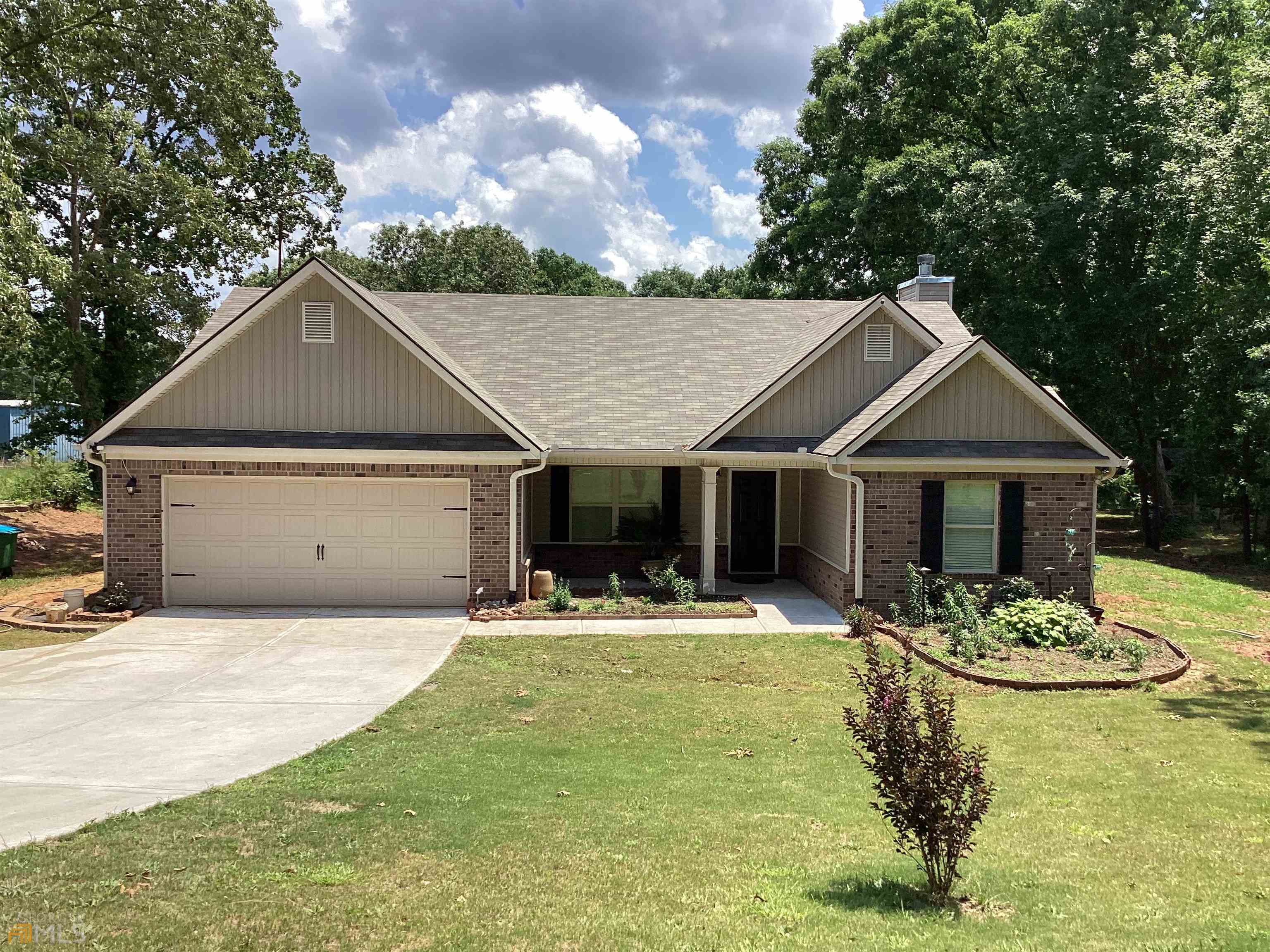 2619 Rat Kinney Road Statham, GA 30666 - Photo 1 of 1 a front view of a house with a yard and garage