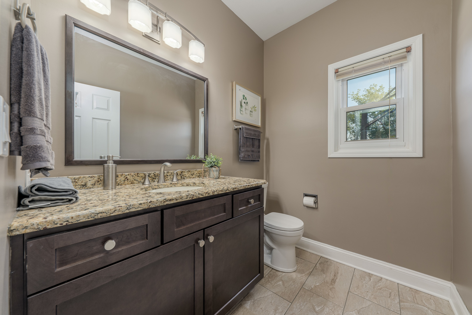 113 Bittersweet Lane Streamwood, IL 60107 - Photo 11 of 24 a bathroom with a granite countertop toilet sink and mirror