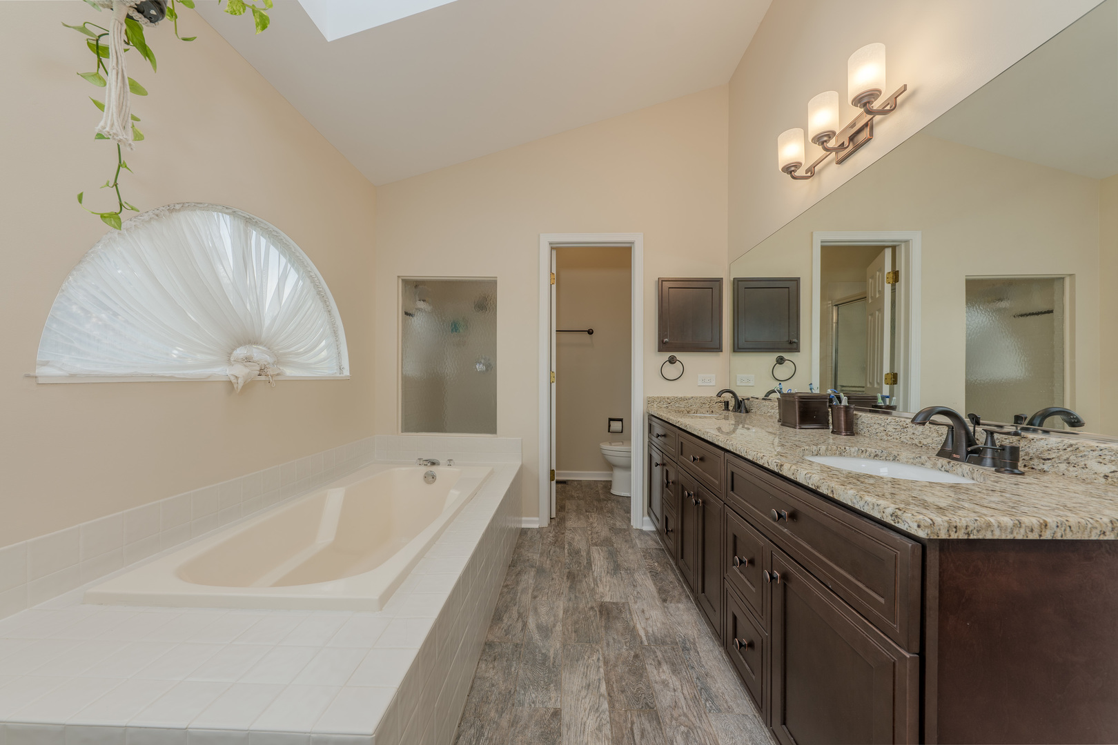 113 Bittersweet Lane Streamwood, IL 60107 - Photo 14 of 24 a spacious bathroom with a tub double sink and mirror