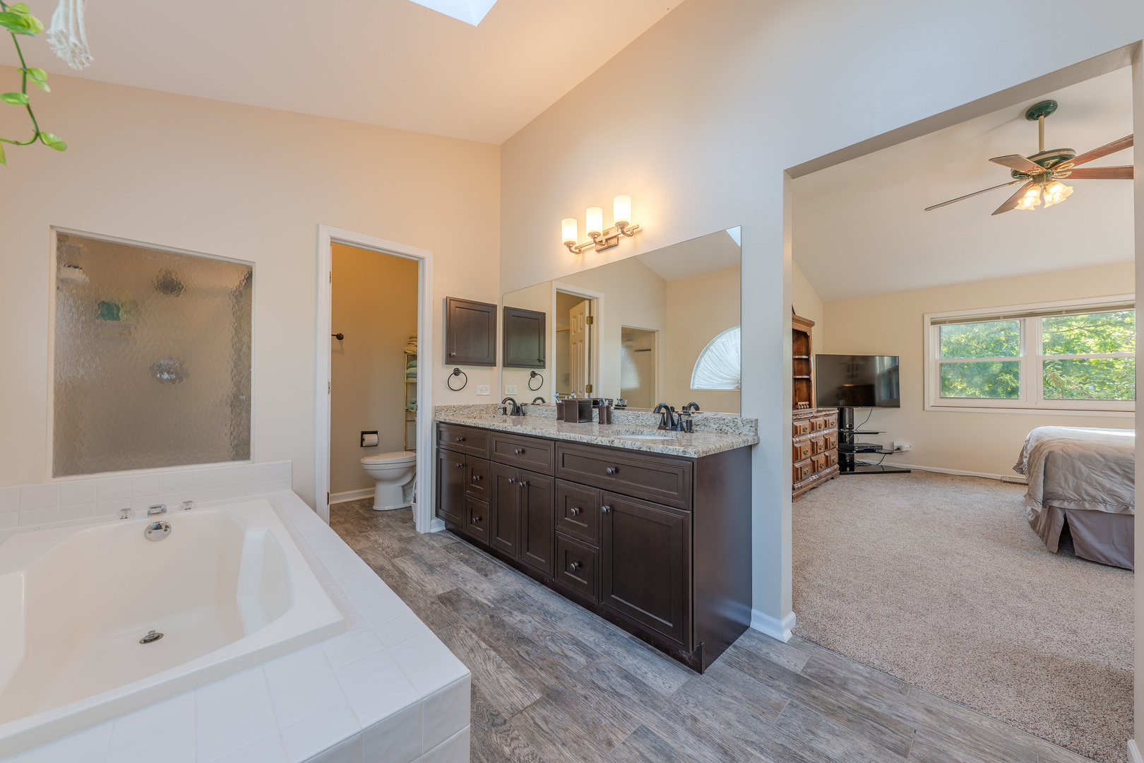 113 Bittersweet Lane Streamwood, IL 60107 - Photo 15 of 24 a large bathroom with a tub sink and mirror
