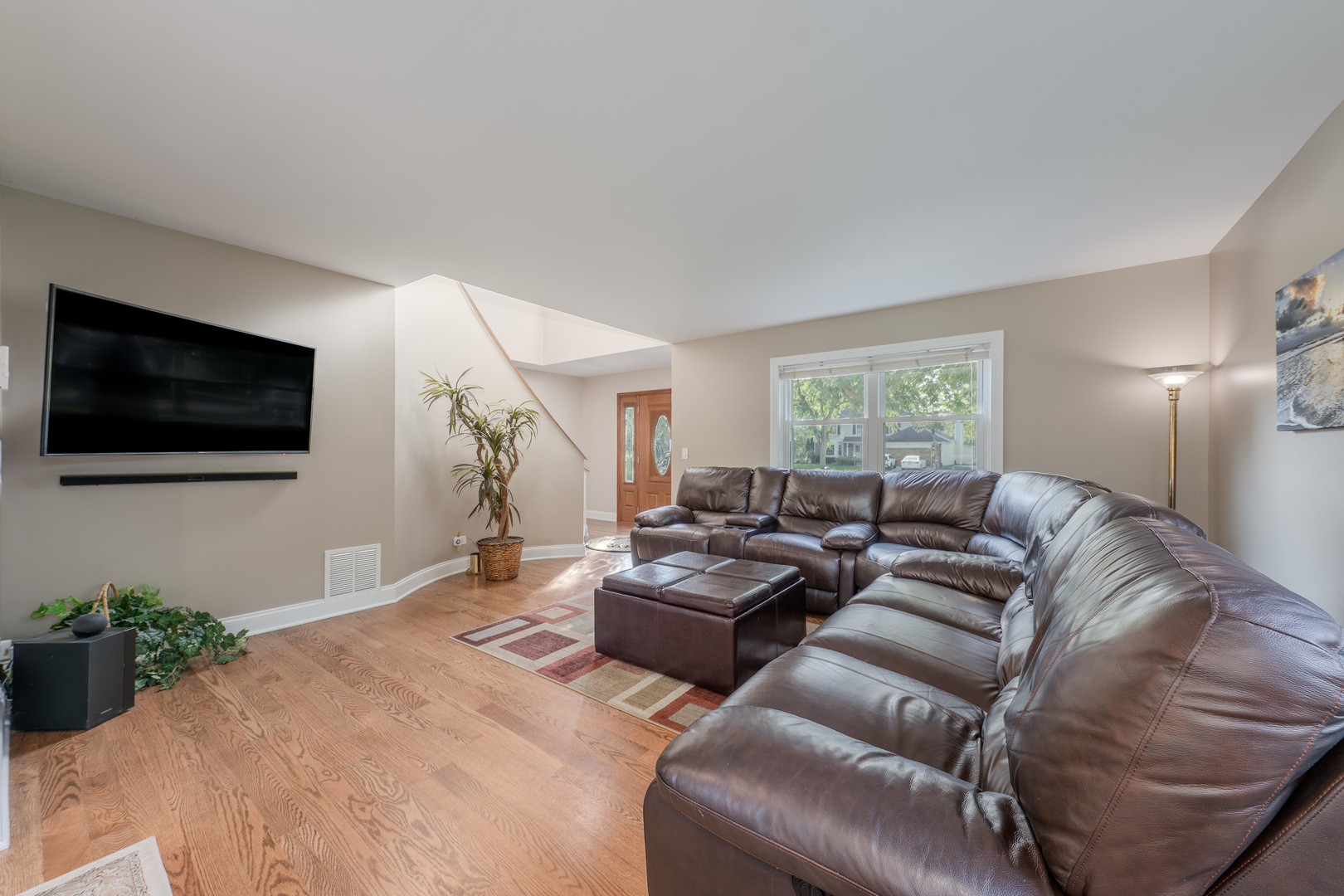 113 Bittersweet Lane Streamwood, IL 60107 - Photo 3 of 24 a living room with furniture and a flat screen tv