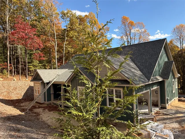 a view of a patio with table and chairs with wooden floor and fence