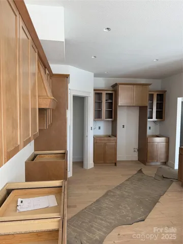 a view of a yard with plants and trees